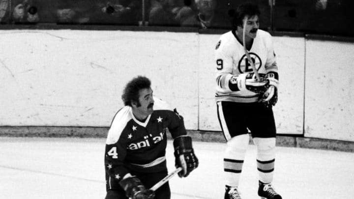 BOSTON, MA. - 1970's: Tommy Williams #14 of the Washington Capitals skates against Joe Zanussi #29 in game against the Boston Bruins at Boston Garden. (Photo by Steve Babineau/NHLI via Getty Images)