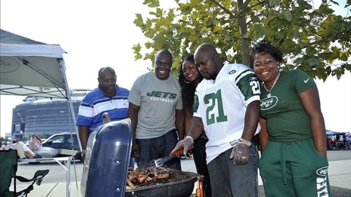 Sep 8, 2013; East Rutherford, NJ, USA; From left, football fans Kerlix Louisjeam , Ken Cooper Ayana Louisjeam , Gerald Cajuste , and Gemyse Cajuste tailgate before the start of the game between the New York Jets and Tampa Bay Buccaneers at MetLife Stadium. Mandatory Credit: Joe Camporeale-USA TODAY Sports