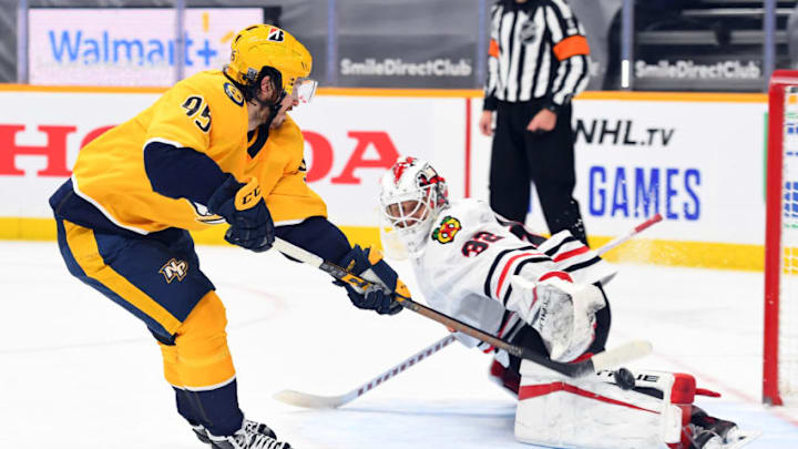 Jan 27, 2021; Nashville, Tennessee, USA; Nashville Predators center Matt Duchene (95) scores the eventual game winner on a shootout shot past Chicago Blackhawks goaltender Kevin Lankinen (32) at Bridgestone Arena. Mandatory Credit: Christopher Hanewinckel-USA TODAY Sports