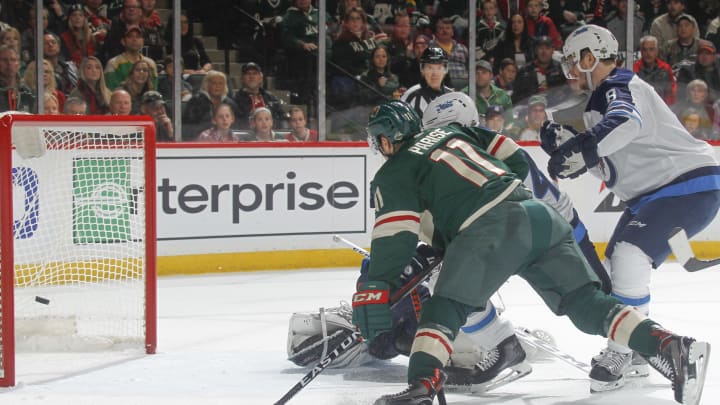 ST. PAUL, MN - APRIL 15: Zach Parise #11 of the Minnesota Wild scores a goal with Jacob Trouba #8 and Connor Hellebuyck #37 of the Winnipeg Jets defending in Game Three of the Western Conference First Round during the 2018 NHL Stanley Cup Playoffs at the Xcel Energy Center on April 15, 2018 in St. Paul, Minnesota. (Photo by Bruce Kluckhohn/NHLI via Getty Images)