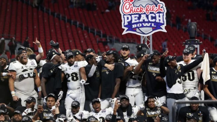 ATLANTA, GA - JANUARY 01: The UCF Knights celebrate defeating the Auburn Tigers 34-27 to win the Chick-fil-A Peach Bowl at Mercedes-Benz Stadium on January 1, 2018 in Atlanta, Georgia. (Photo by Streeter Lecka/Getty Images)