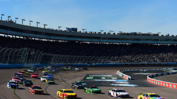 AVONDALE, ARIZONA - NOVEMBER 10: Kyle Busch, driver of the #18 M&M's Toyota, and Joey Logano, driver of the #22 Shell Pennzoil Ford, lead the field to turn one after taking the green flag to start the Monster Energy NASCAR Cup Series Bluegreen Vacations 500 at ISM Raceway on November 10, 2019 in Avondale, Arizona. (Photo by Jared C. Tilton/Getty Images)