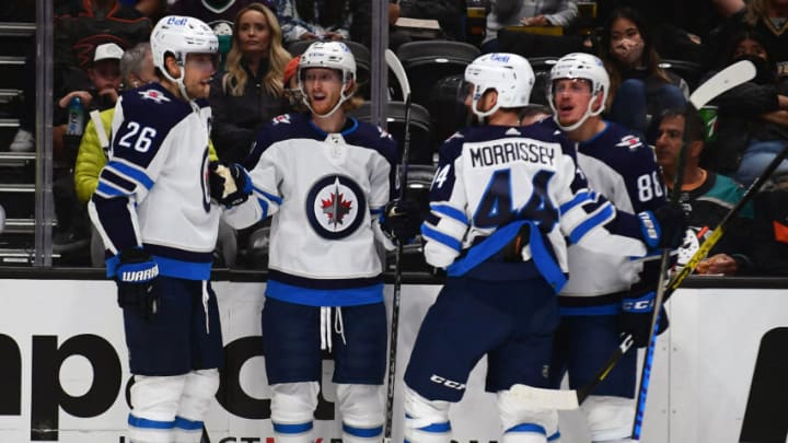 Oct 13, 2021; Anaheim, California, USA; Winnipeg Jets left wing Kyle Connor (81) celebrates with right wing Blake Wheeler (26) defenseman Josh Morrissey (44) and defenseman Nate Schmidt (88) his goal scored against the Anaheim Ducks during the second period at Honda Center. Mandatory Credit: Gary A. Vasquez-USA TODAY Sports