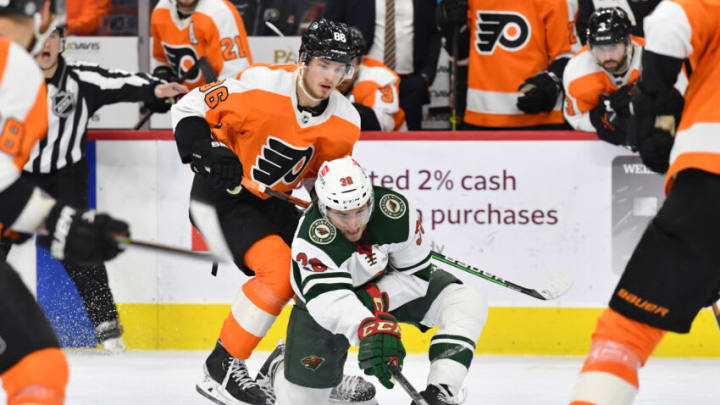 Mar 3, 2022; Philadelphia, Pennsylvania, USA; Minnesota Wild right wing Ryan Hartman (38) controls the puck against Philadelphia Flyers left wing Joel Farabee (86) during the third period at Wells Fargo Center. Mandatory Credit: Eric Hartline-USA TODAY Sports