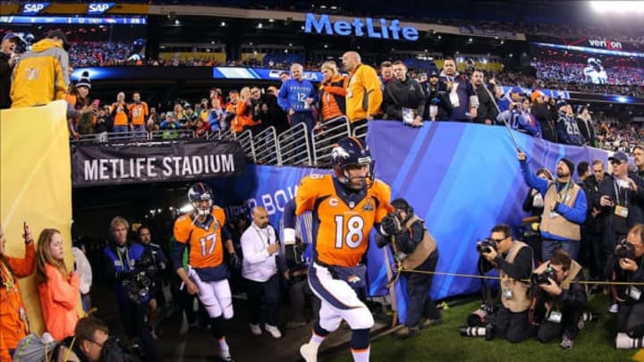 Feb 2, 2014; East Rutherford, NJ, USA; Denver Broncos quarterback Peyton Manning (18) runs onto the field for warms up before Super Bowl XLVIII at MetLife Stadium. Mandatory Credit: Brad Penner-USA TODAY Sports