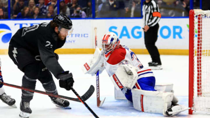 TAMPA, FLORIDA – APRIL 02: Jake Allen #34 of the Montreal Canadiens stops a shot from Brayden Point #21 of the Tampa Bay Lightning in the third period during a game at Amalie Arena on April 02, 2022 in Tampa, Florida. (Photo by Mike Ehrmann/Getty Images)