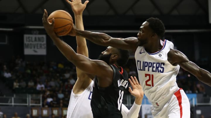 HONOLULU, HI – OCTOBER 03: James Harden #13 of the Houston Rockets has his shot swatted away by Patrick Beverley #21 of the LA Clippers during the first half of their game at the Stan Sheriff Center on October 3, 2019, in Honolulu, Hawaii. (Photo by Darryl Oumi/Getty Images)