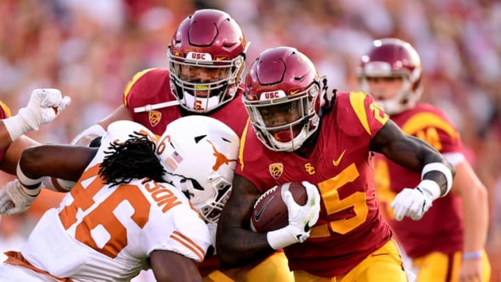 LOS ANGELES, CA - SEPTEMBER 16: Ronald Jones II #25 of the USC Trojans carries the ball as he is hit by Malik Jefferson #46 of the Texas Longhorns during the first quarter at Los Angeles Memorial Coliseum on September 16, 2017 in Los Angeles, California. (Photo by Harry How/Getty Images)