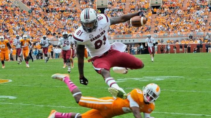 Oct 19, 2013; Knoxville, TN, USA; South Carolina Gamecocks tight end Rory Anderson (81) leaps over Tennessee Volunteers defensive back Cameron Sutton (23) as he rushes for yardage during the second half at Neyland Stadium. Tennessee won 23-21. Mandatory Credit: Jim Brown-USA TODAY Sports