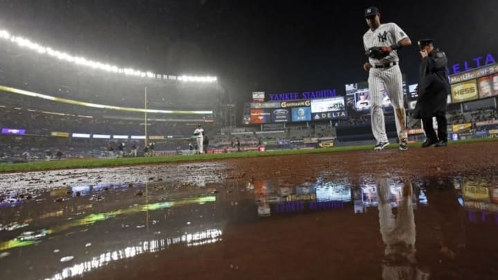 Sep 30, 2016; Bronx, NY, USA; New York Yankees right fielder Aaron Hicks (31) heads for the dugout in the rain during the fourth inning against the Baltimore Orioles at Yankee Stadium. Mandatory Credit: Adam Hunger-USA TODAY Sports