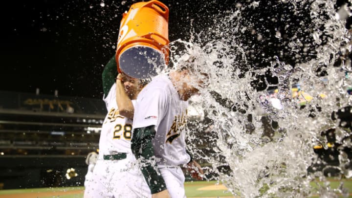 OAKLAND, CALIFORNIA - JUNE 20: Matt Chapman #26 of the Oakland Athletics is dumped with water by Matt Olson #28 after Chapman hit a walk-off home run to beat the Tampa Bay Rays at Ring Central Coliseum on June 20, 2019 in Oakland, California. (Photo by Ezra Shaw/Getty Images)