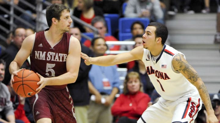 Dec 11, 2013; Tucson, AZ, USA; New Mexico State Aggies guard Kevin Aronis (5) is defended by Arizona Wildcats guard Gabe York (1) during the second half at McKale Center. Arizona won 48-74. Mandatory Credit: Casey Sapio-USA TODAY Sports
