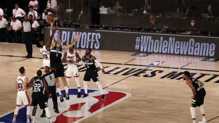 Bam Adebayo #13 of the Miami Heat and Brook Lopez #11 of the Milwaukee Bucks fight for possession during tip-off in Game Two. (Photo by Mike Ehrmann/Getty Images)
