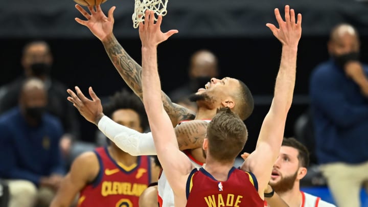 May 5, 2021; Cleveland, Ohio, USA; Portland Trail Blazers guard Damian Lillard (0) drives to the basket against Cleveland Cavaliers forward Dean Wade (32) during the third quarter at Rocket Mortgage FieldHouse. Mandatory Credit: Ken Blaze-USA TODAY Sports