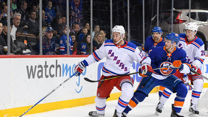 BROOKLYN, NY – APRIL 05: New York Rangers Center Kevin Hayes (13) brings the puck out from behind the goal defended by New York Islanders Winger Chris Wagner (21) during the third period at the Barclays Center in Brooklyn,NY (Photo by Dennis Schneidler/Icon Sportswire via Getty Images)