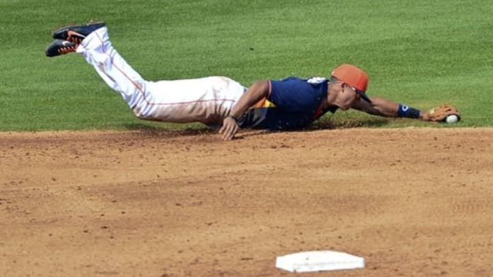 Mar 5, 2014; Kissimmee, FL, USA; Houston Astros shortstop Carlos Correa (84) dives for a ground ball during the fourth inning against the Detroit Tigers at Osceola County Stadium. Mandatory Credit: Tommy Gilligan-USA TODAY Sports