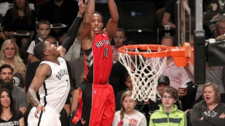 Apr 27, 2014; Brooklyn, NY, USA; Toronto Raptors guard DeMar DeRozan (10) shoots over Brooklyn Nets guard Joe Johnson (7) in the second half of game four of the first round of the 2014 NBA Playoffs at the Barclays Center. The Toronto Raptors won 87-79. Mandatory Credit: Noah K. Murray-USA TODAY Sports