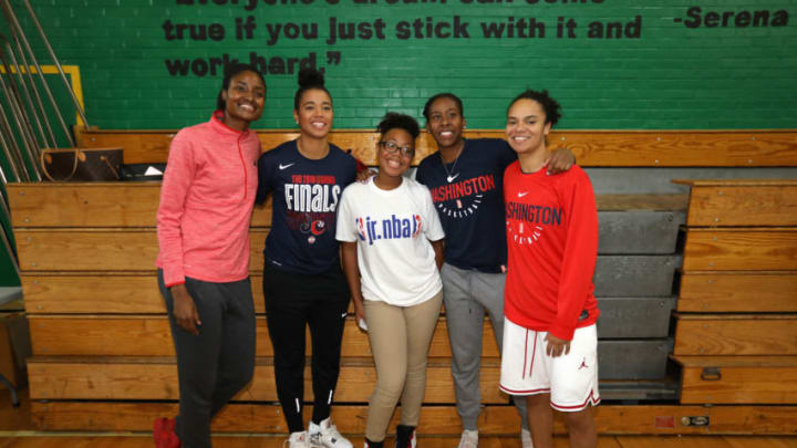 WASHINGTON D.C - SEPTEMBER 11: LaToya Sanders, Natasha Cloud, Ariel Atkins, and Kristi Toliver, of the Washington Mystics pose with a fan at the 2018 Jr. WNBA Clinic on September 11, 2018 at Hart Middle School in Washington D.C. NOTE TO USER: User expressly acknowledges and agrees that, by downloading and/or using this Photograph, user is consenting to the terms and conditions of Getty Images License Agreement. Mandatory Copyright Notice: Copyright 2018 NBAE (Photo by Stephen Gosling/NBAE via Getty Images)