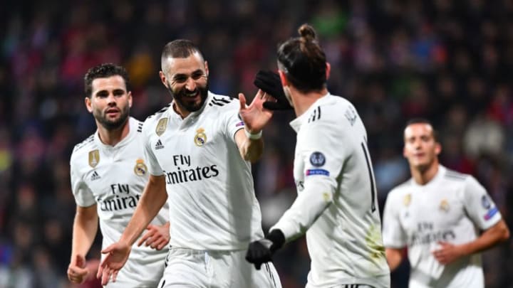 Real Madrid's French forward Karim Benzema (C) celebrates with teammates after scoring during the UEFA Champions League group G football match Viktoria Plzen v Real Madrid in Plzen, Czech Republic on November 7, 2018. (Photo by JOE KLAMAR / AFP) (Photo credit should read JOE KLAMAR/AFP/Getty Images)