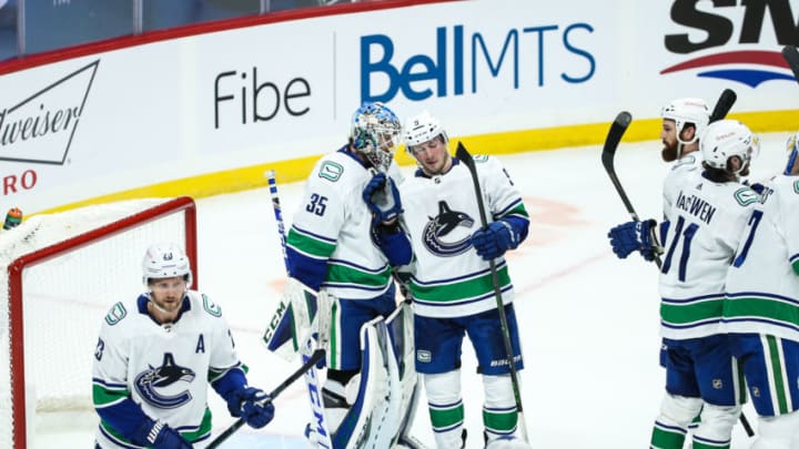 Jan 30, 2021; Winnipeg, Manitoba, CAN; Vancouver Canucks goalie Thatcher Demko (35) is congratulated by Vancouver Canucks forward J.T. Miller (9) on his win against the Winnipeg Jets at the end of the third period at Bell MTS Place. Mandatory Credit: Terrence Lee-USA TODAY Sports