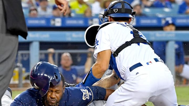 LOS ANGELES, CA - JULY 31: Lorenzo Cain #6 of the Milwaukee Brewers is tagged out at home by Austin Barnes #15 of the Los Angeles Dodgers on a throw from Enrique Hernandez in the third inning at Dodger Stadium on July 31, 2018 in Los Angeles, California. (Photo by Jayne Kamin-Oncea/Getty Images)