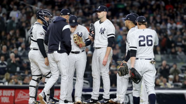NEW YORK, NEW YORK – OCTOBER 18: Aaron Boone #17 of the New York Yankees talks with James Paxton #65 on the mound against the Houston Astros during the sixth inning in game five of the American League Championship Series at Yankee Stadium on October 18, 2019 in New York City. (Photo by Elsa/Getty Images)