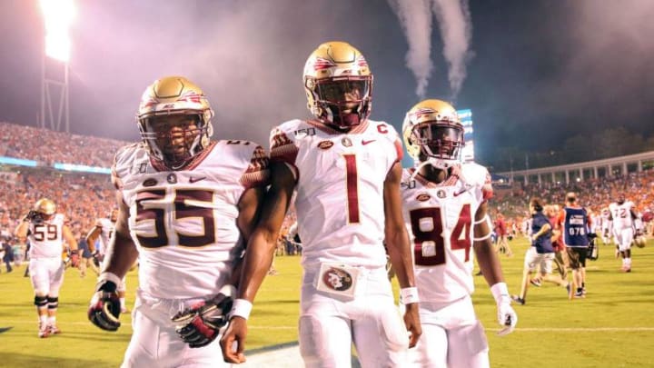 CHARLOTTESVILLE, VA - SEPTEMBER 14: James Blackman #1 of the Florida State Seminoles walks off the field between Dontae Lucas #55 and Adarius Dent #84 after the end of a game against the Virginia Cavaliers at Scott Stadium on September 14, 2019 in Charlottesville, Virginia. (Photo by Ryan M. Kelly/Getty Images)