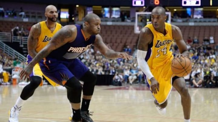 Oct 21, 2014; Anaheim, CA, USA; Los Angeles Lakers guard Kobe Bryant (24) drives against Phoenix Suns forward P.J. Tucker (17) during the fourth quarter at Honda Center. Mandatory Credit: Richard Mackson-USA TODAY Sports Oct 21, 2014; Anaheim, CA, USA; Los Angeles Lakers guard Kobe Bryant (24) drives against Phoenix Suns forward P.J. Tucker (17) during the fourth quarter at Honda Center. Mandatory Credit: Richard Mackson-USA TODAY Sports