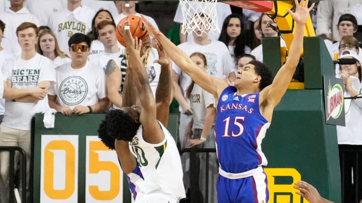 Jan 23, 2023; Waco, Texas, USA; Baylor Bears guard Adam Flagler (10) has his shot blocked by Kansas Jayhawks guard Kevin McCullar Jr. (15) during the first half at Ferrell Center. Mandatory Credit: Chris Jones-USA TODAY Sports