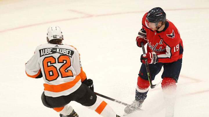 WASHINGTON, DC - MAY 07: Nicolas Aube-Kubel #62 of the Philadelphia Flyers and Nicklas Backstrom #19 of the Washington Capitals go after the puck in the first period at Capital One Arena on May 07, 2021 in Washington, DC. (Photo by Rob Carr/Getty Images)
