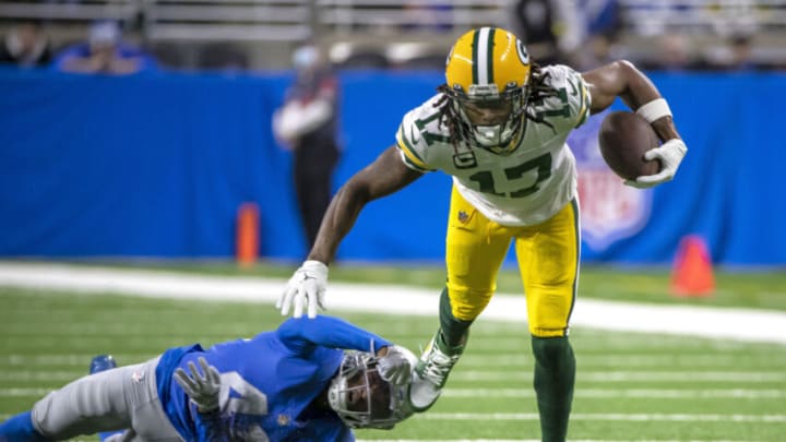 Jan 9, 2022; Detroit, Michigan, USA; Green Bay Packers wide receiver Davante Adams (17) breaks a tackle attempt from Detroit Lions cornerback AJ Parker (41) during the first half at Ford Field. Mandatory Credit: David Reginek-USA TODAY Sports