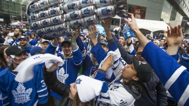 TORONTO, ON - APRIL 12: Fans parade around a makeshift replica of the Stanley Cup, this one fashioned from beer cans. Toronto Maple Leaf fans gather at Maple Leaf Square, outside the Air Canada Centre, for the 1st game of the playoffs between Toronto and Boston Bruins. (Rick Madonik/Toronto Star via Getty Images)