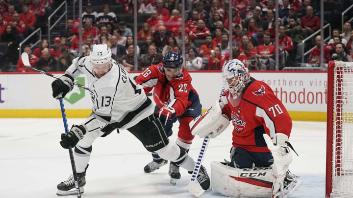 WASHINGTON, DC – FEBRUARY 04: Kyle Clifford #13 of the Los Angeles Kings controls the puck against Nic Dowd #26 of the Washington Capitals in front of Braden Holtby #70 in the second period at Capital One Arena on February 04, 2020 in Washington, DC. (Photo by Patrick McDermott/NHLI via Getty Images)