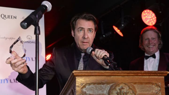 LONDON, ENGLAND – DECEMBER 01: Jonathan Ross (C) accepts The Snow Queen Cigar Smoker of the Year from Ranald Macdonald (R) at The Snow Queen Cigar Smoker of the Year Awards Dinner 2015 at Boisdale, Canary Wharf, on December 1, 2015 in London, England. (Photo by David M. Benett/Dave Benett/Getty Images for Boisdale Canary Wharf)