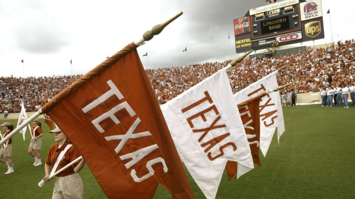 AUSTIN, TX – AUGUST 31: “Texas” flags are brought on to the field during an intermission in the game between the University of Texas at Austin Longhorns and the University of New Mexico Aggies at Texas Memorial Stadium on August 31, 2003 in Austin, Texas. Texas Football defeated New Mexico 66-7. (Photo by Stephen Dunn/Getty Images)