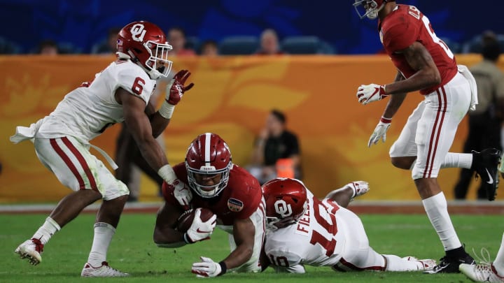 MIAMI, FL – DECEMBER 29: Josh Jacobs #8 of the Alabama Crimson Tide is tackled by Patrick Fields #10 of the Oklahoma Sooners . (Photo by Mike Ehrmann/Getty Images)
