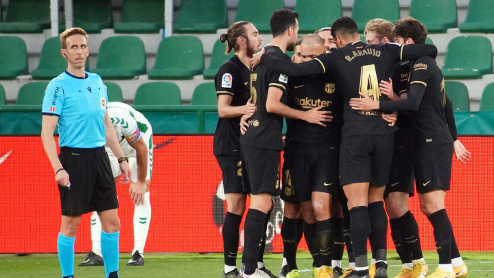 Barcelona players celebrate their second goal scored by Riqui Puig during the match against Elche CF. (Photo by JOSE JORDAN / AFP) (Photo by JOSE JORDAN/AFP via Getty Images)