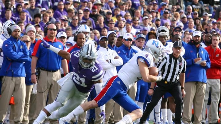 Nov 26, 2016; Manhattan, KS, USA; Kansas Jayhawks wide receiver Tyler Patrick (4) runs away from Kansas State Wildcats defensive back Kendall Adams (21) during a game at Bill Snyder Family Football Stadium. The Wildcats won the game, 34-19. Mandatory Credit: Scott Sewell-USA TODAY Sports