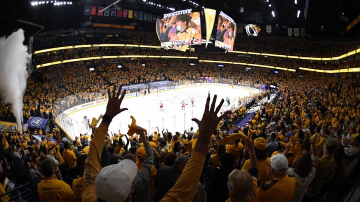 May 23, 2021; Nashville, Tennessee, USA; Nashville Predators fans celebrate after a goal by Nashville Predators center Luke Kunin (11) during the first period against the Carolina Hurricanes in game four of the first round of the 2021 Stanley Cup Playoffs at Bridgestone Arena. Mandatory Credit: Christopher Hanewinckel-USA TODAY Sports
