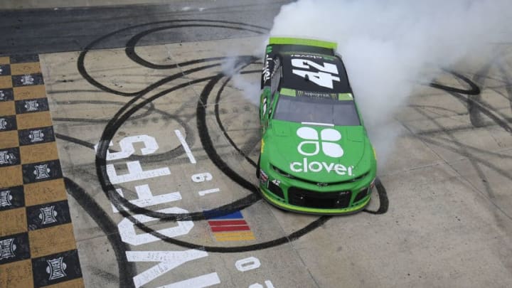 DOVER, DELAWARE - OCTOBER 06: Kyle Larson, driver of the #42 Clover Chevrolet, celebrates with a burnout after winning the Monster Energy NASCAR Cup Series Drydene 400 at Dover International Speedway on October 06, 2019 in Dover, Delaware. (Photo by Chris Trotman/Getty Images)