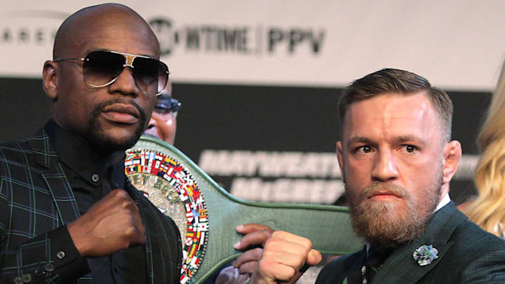 Boxer Floyd Mayweather Jr. (L) and MMA figher Connor Mcgregor pose during a media press conference August 23, 2017 at the MGM Grand in Las Vegas, Nevada.Mayweather, the 40-year-old undefeated former welterweight boxing champion, has been lured out of retirement to face McGregor, a star of mixed martial arts' Ultimate Fighting Championship. The two men meet in a 12-round contest under boxing rules on August 26th that is tipped to become the richest fight in history. / AFP PHOTO / John Gurzinski (Photo credit should read JOHN GURZINSKI/AFP/Getty Images)