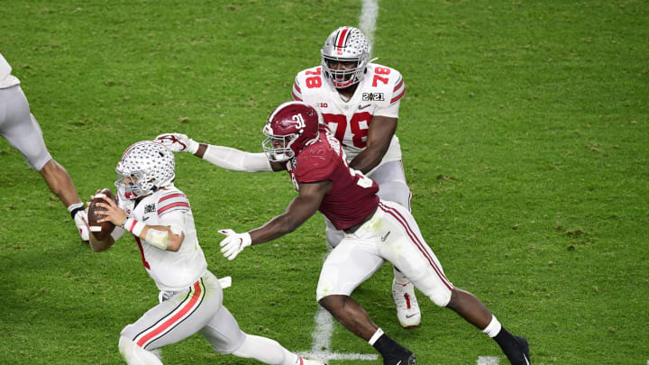 Jan 11, 2021; Miami Gardens, FL, USA; Ohio State Buckeyes quarterback Justin Fields (1) runs away from Alabama Crimson Tide linebacker Will Anderson Jr. (31) in the fourth quarter in the 2021 College Football Playoff National Championship Game at Hard Rock Stadium. Mandatory Credit: Douglas DeFelice-USA TODAY Sports