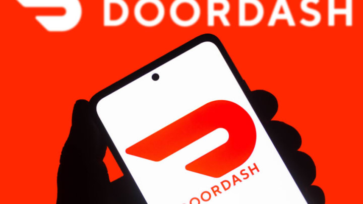 BRAZIL - 2021/10/30: In this photo illustration the DoorDash logo seen displayed on a smartphone and on the background. (Photo Illustration by Rafael Henrique/SOPA Images/LightRocket via Getty Images)