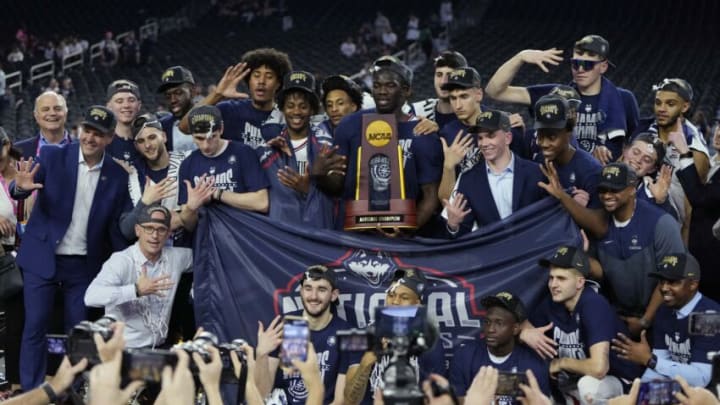 Apr 3, 2023; Houston, TX, USA; Connecticut Huskies players and Connecticut Huskies head coach Dan Hurley (left) celebrate after defeating the San Diego State Aztecs in the national championship game of the 2023 NCAA Tournament at NRG Stadium. Mandatory Credit: Bob Donnan-USA TODAY Sports