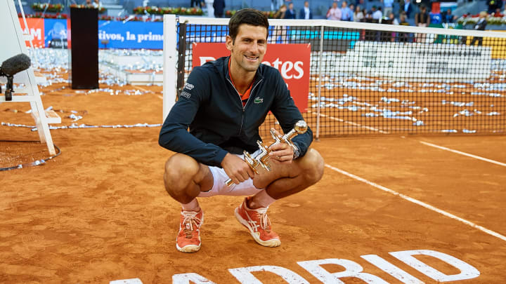 MADRID, SPAIN – MAY 12: Novak Djokovic of Serbia poses on the court as he holds the winners trophy following the men’s singles final against Stefano Tsitsipas of Greece during day 9 of the Mutua Madrid Open at La Caja Magica on May 12, 2019 in Madrid, Spain. (Photo by David Aliaga/MB Media/Getty Images)