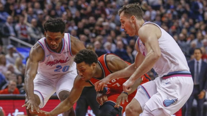 Toronto Raptors guard Kyle Lowry (7) splits the defence as Miami Heat forward Justise Winslow (20) and Miami Heat guard Goran Dragic (7) collapse. Toronto Star/Rick Madonik (Rick Madonik/Toronto Star via Getty Images)