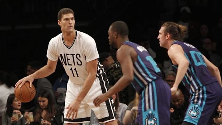 Nov 4, 2016; Brooklyn, NY, USA; Brooklyn Nets center Brook Lopez (11) looks to pass the ball against Charlotte Hornets guard Kemba Walker (15) and forward Spencer Hawes (00) in the second quarter at Barclays Center. Mandatory Credit: Nicole Sweet-USA TODAY Sports