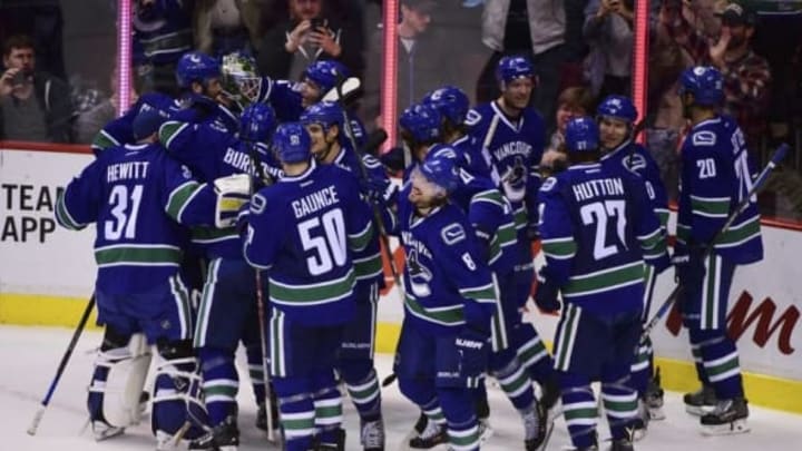 Oct 18, 2016; Vancouver, British Columbia, CAN; The Vancouver Canucks celebrate the win against the St. Louis Blues during overtime at Rogers Arena. The Vancouver Canucks won 2-1 in overtime. Mandatory Credit: Anne-Marie Sorvin-USA TODAY Sports