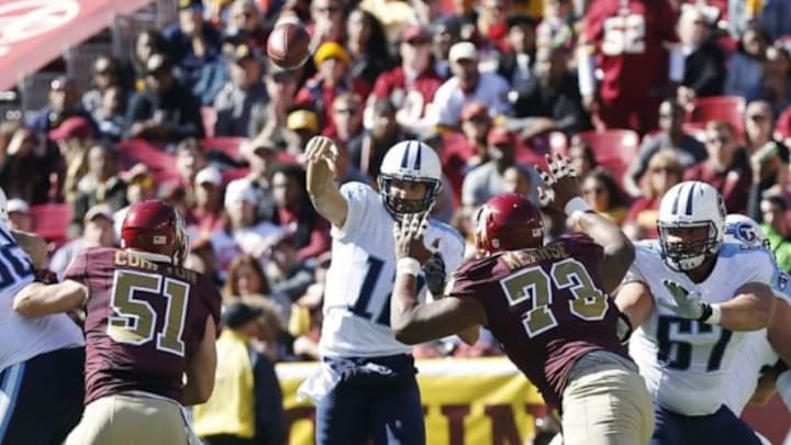 Oct 19, 2014; Landover, MD, USA; Tennessee Titans quarterback Charlie Whitehurst (12) throws the ball against the Washington Redskins in the second quarter at FedEx Field. Mandatory Credit: Geoff Burke-USA TODAY Sports