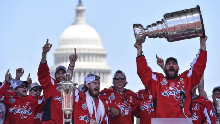 WASHINGTON, DC - JUNE 12: Washington Capitals left wing Alex Ovechkin (8) hoists the Stanley Cup alongside his teammates during the victory parade and rally on the National Mall on June 12, 2018 in Washington, D.C. (Photo by Ricky Carioti/The Washington Post via Getty Images)